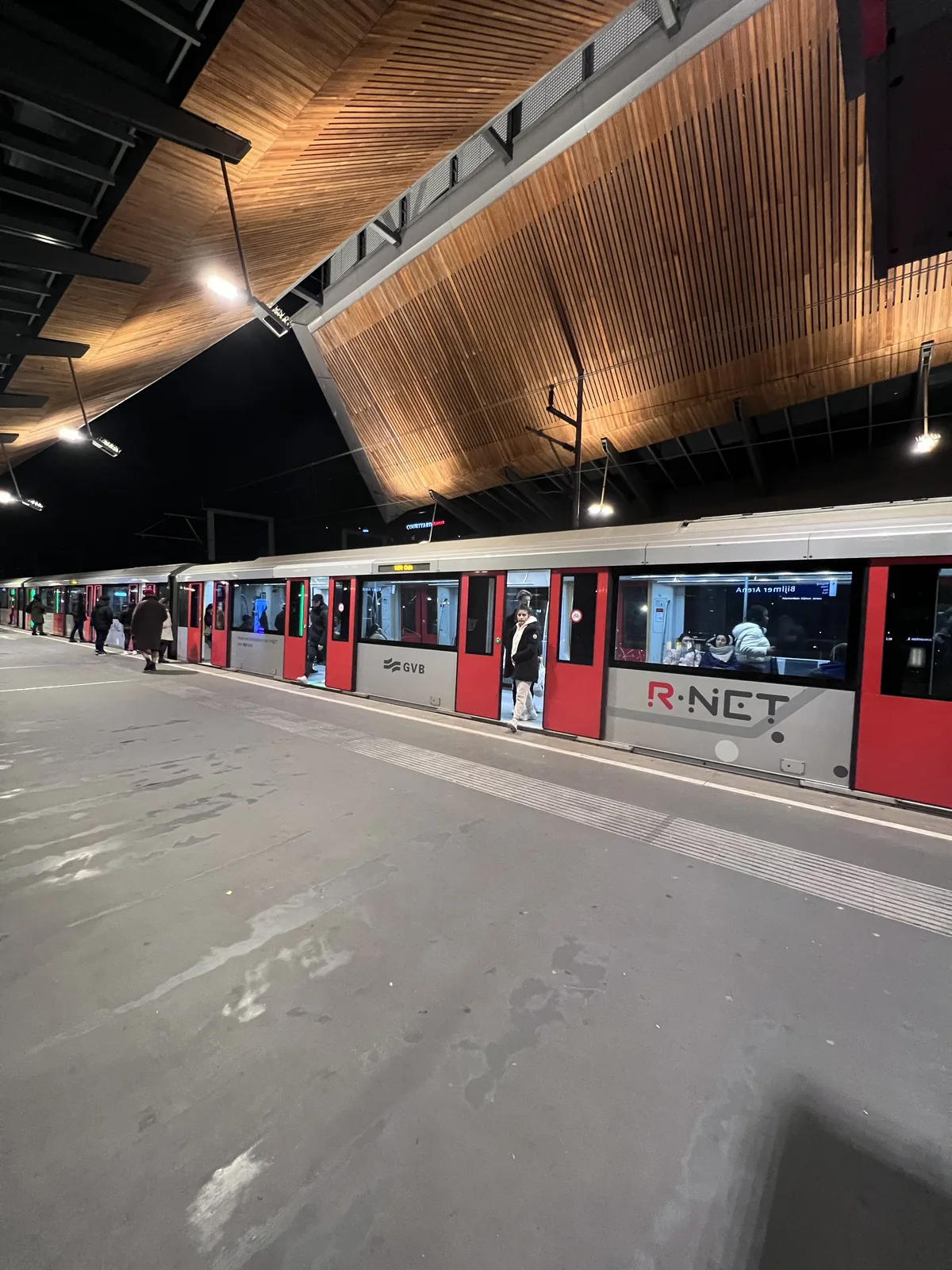 Röd och silverfärgad tågdekor fotograferad vid en station.